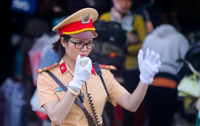 Nữ CSGT cầm loa điều tiết giao thông ở TP HCM